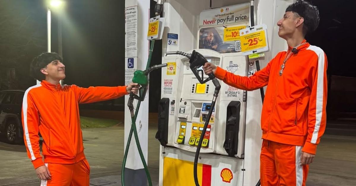 Justin Guzman in his orange tracksuit with another content creator