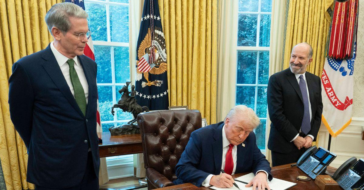 Donald Trump signing executive orders in the Oval Office. 