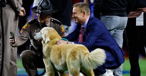 Kirk and Ben Herbstreit posing with an officer before between the Florida Gators and the Florida State Seminoles game on Nov. 25, 2023