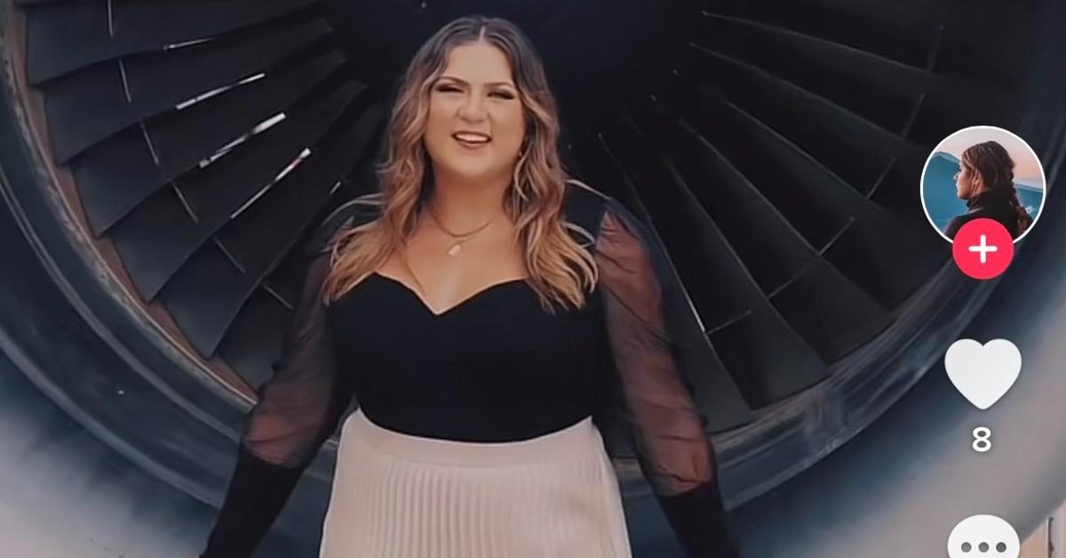 TikTok creator Janelle poses in front of a airplane propeller 