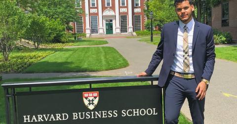 Bryan Arenales from 'Love Island' poses in front of the Harvard Business School sign