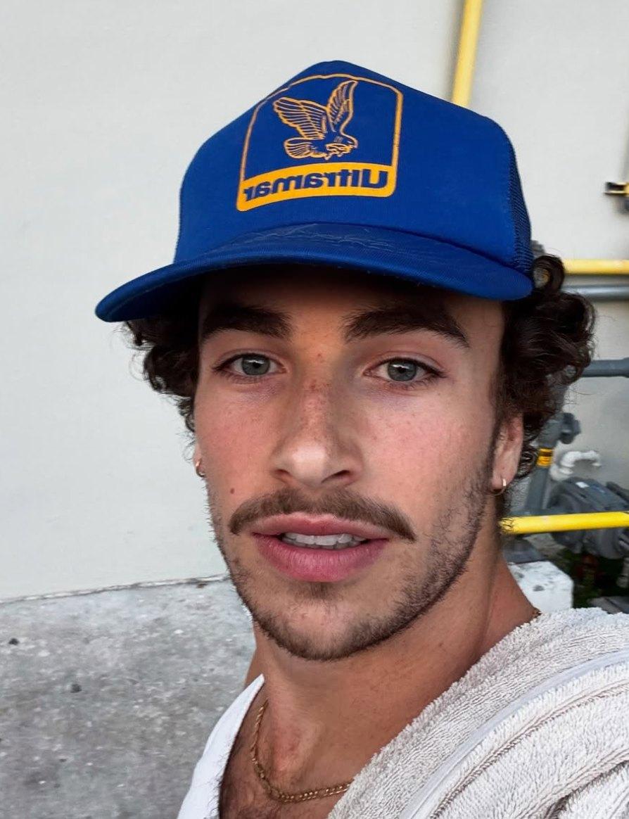Elan Bibas from 'Love Island' Season 7 wearing a blue hat.