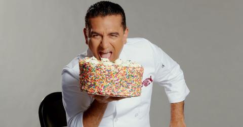 cake boss holding a cake