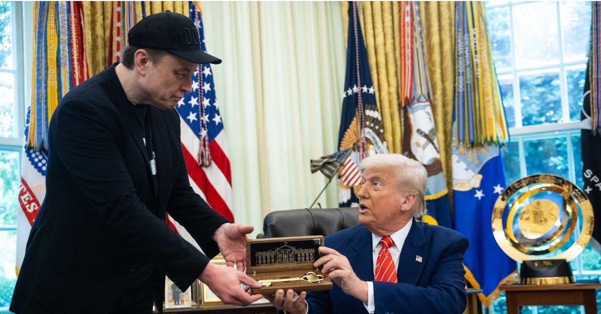 Elon Musk receiving a gift in the Oval Office. 