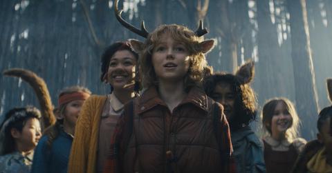 (C) Christian Convery as Gus surrounded by some of the cast of 'Sweet Tooth' in a scene from 'Sweet Tooth' Season 2