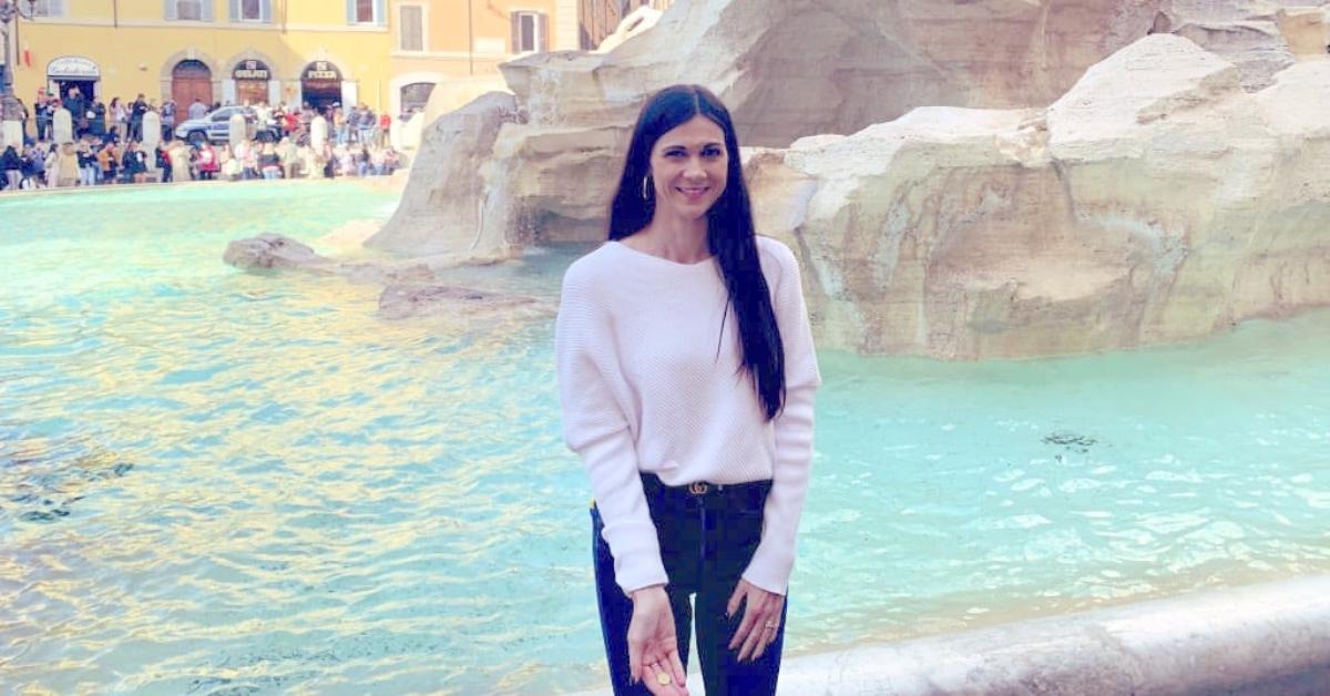Christina Chambers in front of a fountain with a coin.