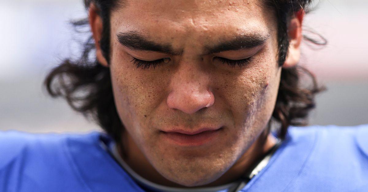 Puka Nacua sheds a tear during the national anthem prior to an NFL football game in 2023