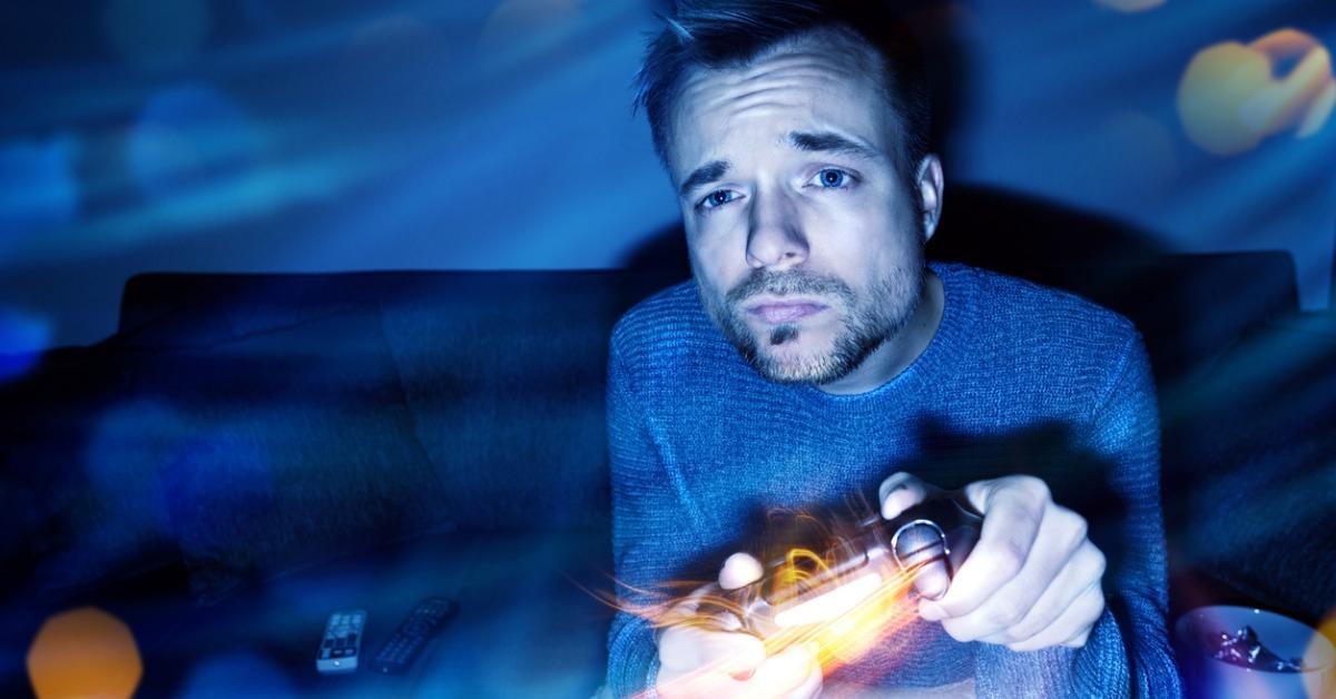 man playing video games at night picture id