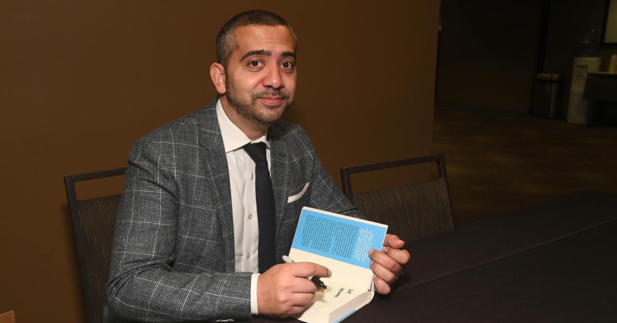 Mehdi Hasan signs copies of his book, 'Win Every Argument: The Art of Debating, Persuading, and Public Speaking'