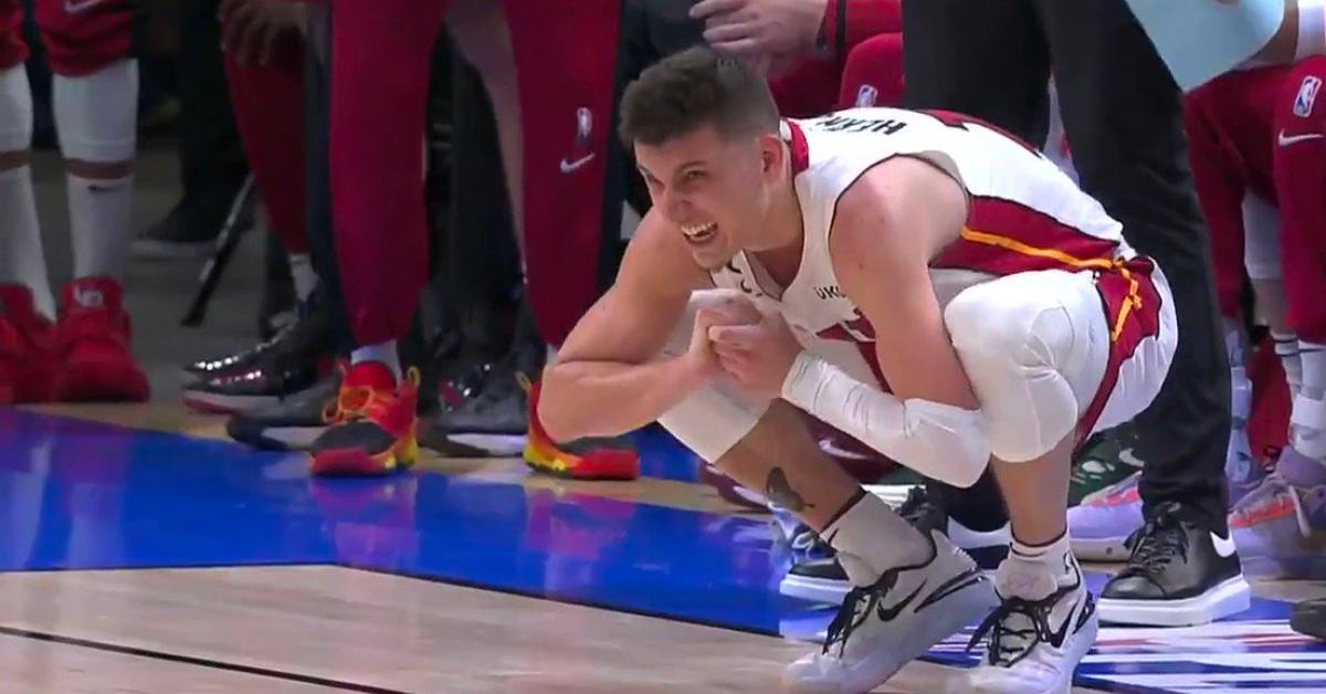 Tyler Herro grabs his injured hand during the Bucks-Heat playoff game on April 16, 2023.