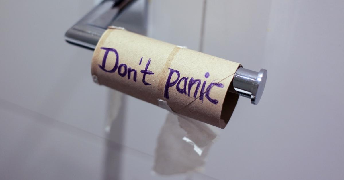 Empty toilet paper roll with "don't panic" written on it