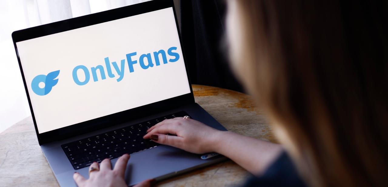 The OnlyFans Logo is displayed on a laptop