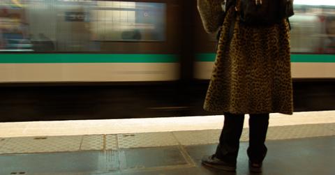 woman waiting on platform for subway train