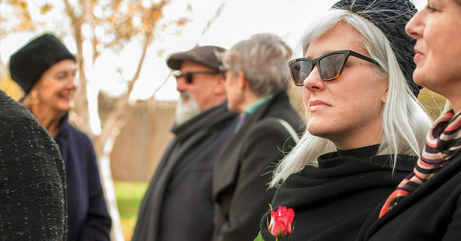 funeral guests in sunglasses