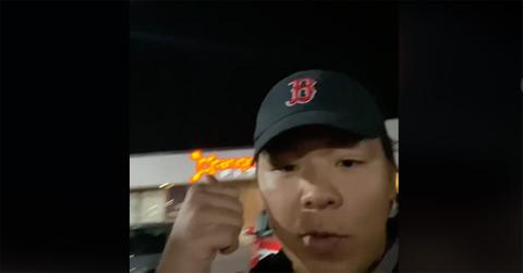 Amigo Chino standing in front of an Orange Theory Fitness.