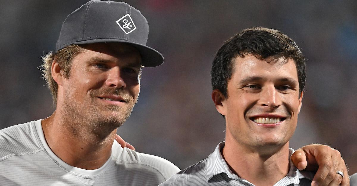 Former Carolina Panthers Gregg Olsen, left, and Luke Kuechly watches his team play against the Buffalo Bills during the second quarter of a preseason game at Bank of America Stadium on August 26, 2022 in Charlotte, North Carolina