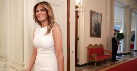 Melania Trump in a white dress at the White House.