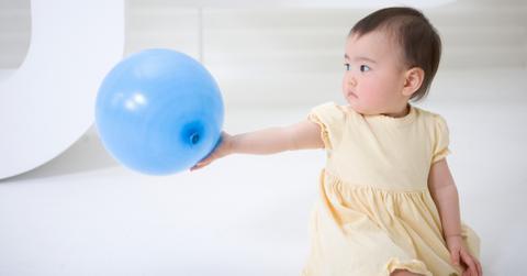 Baby Holding Balloon