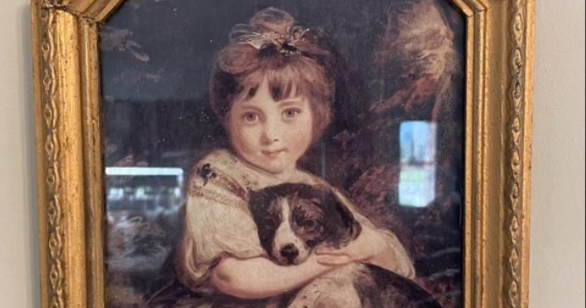 Picture of a little girl holding a puppy in @olivebranchcottage's home decor quiz TikTok. 