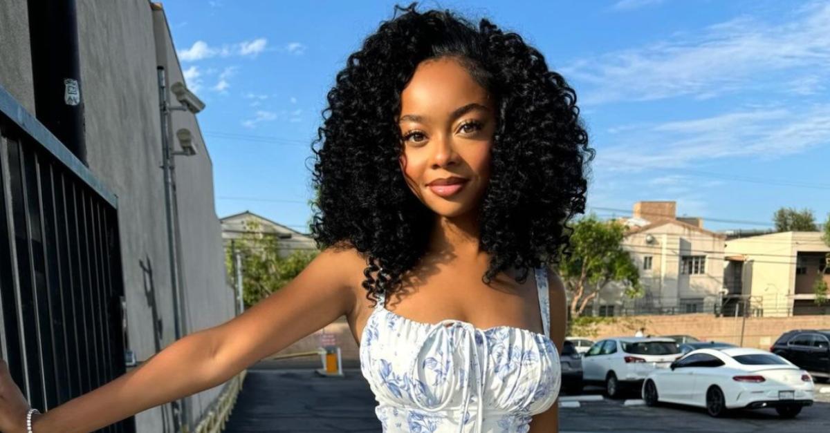 Skai Jackson wearing a blue and white dress.