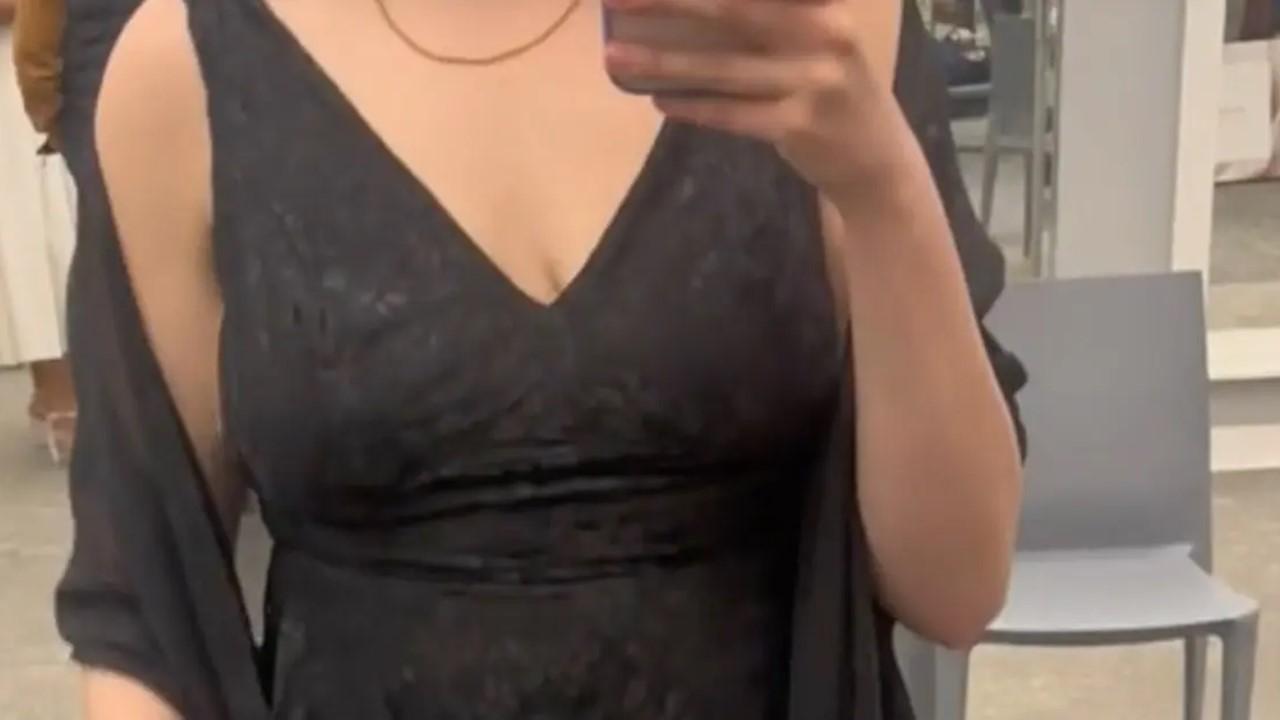 TikTok creator @bipolar.disorder.adhd trying on a black dress David's Bridal