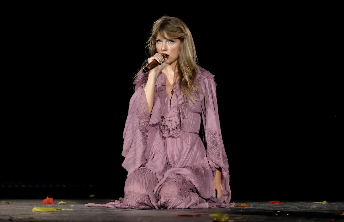 Taylor Swift performs at The Eras Tour in a purple 'folklore' dress.