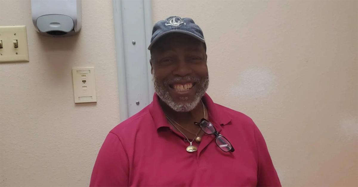 Uncle Ron smiling in a pink polo. 