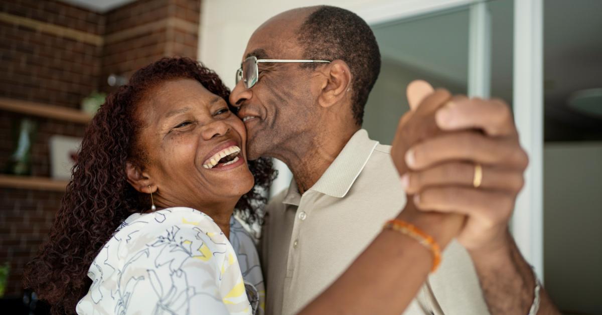 senior couple dancing on the balcony