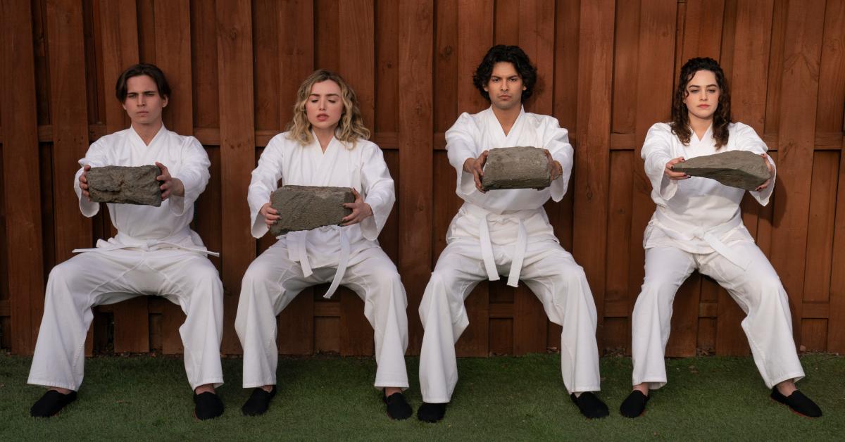 (L-R) Tanner Buchanan as Robby, Peyton List as Tory, Xolo Maridueña as Miguel, and Mary Mouser as Sam in Season 6 of 'Cobra Kai.'