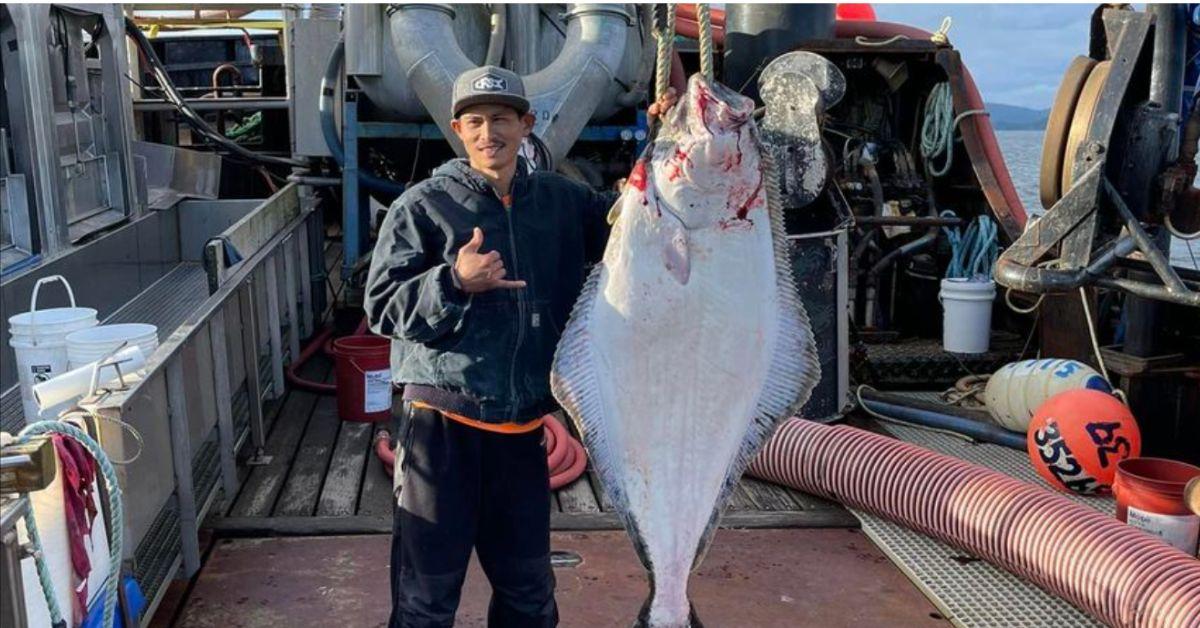 Oj poses with a very large fish on the F/V Wizard