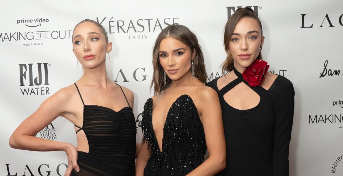 Aurora, Olivia, and Sophia Culpo posing on the red carpet.