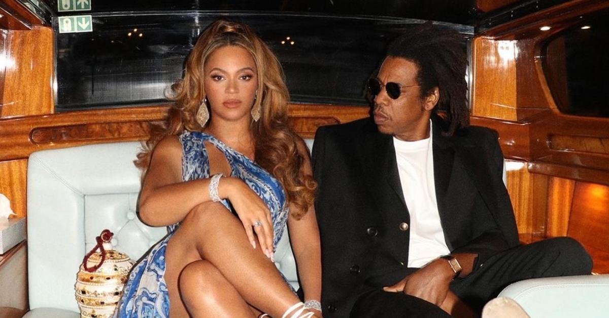 Beyonce crosses her legs and sits next to Jay Z in a luxury car.