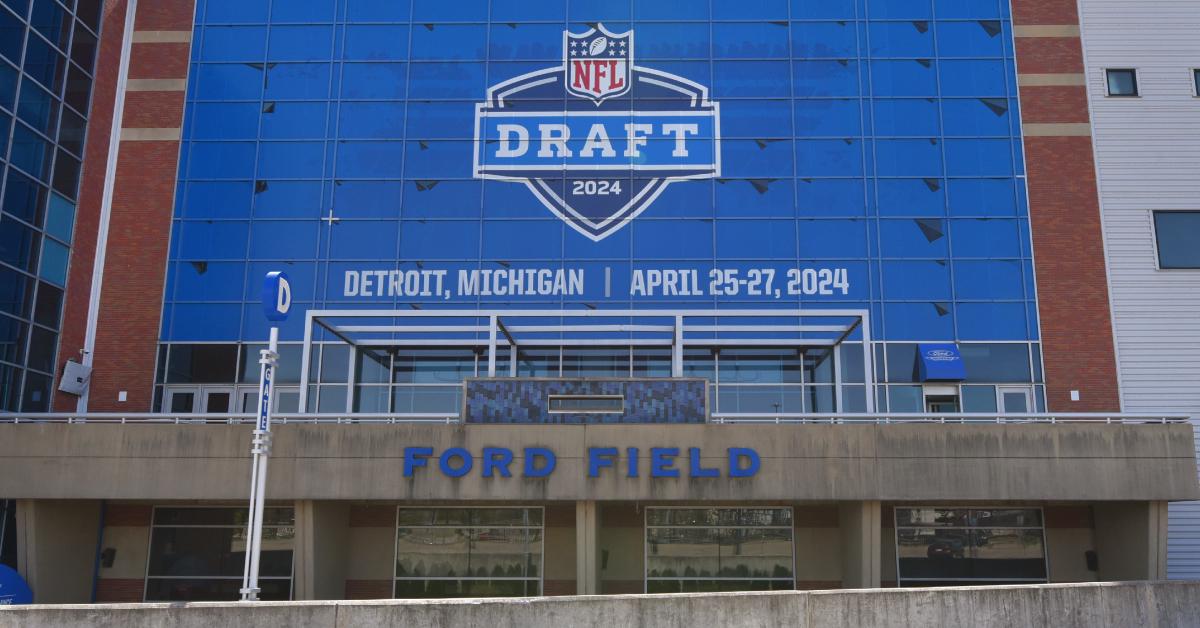 A general exterior view of Ford Field with a sign displayed to announce the upcoming NFL draft.