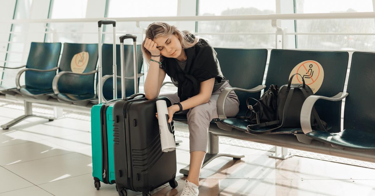 A bored woman sitting in the airport transit lounge.