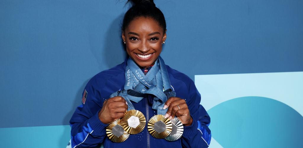 Simone Biles showing off her Olympic medals