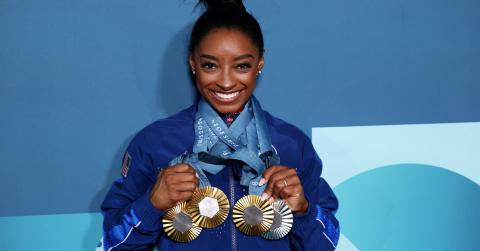 Simone Biles showing off her Olympic medals