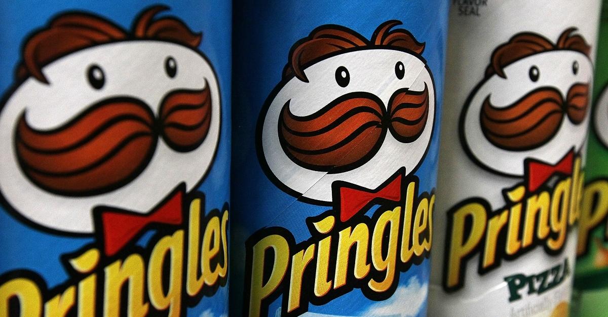 Packages of Pringles potato chips are displayed on a shelf at a market