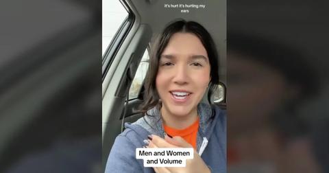 A woman saying that her husband's phone volume is loud and it hurts her ears