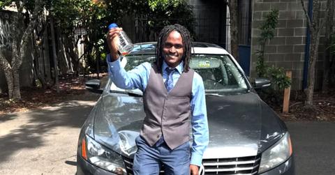 Julian Brown resting on the hood of a car.