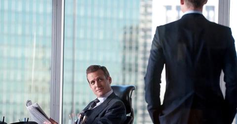 Harvey Specter (Gabriel Macht) sitting at a desk in 'Suits.'