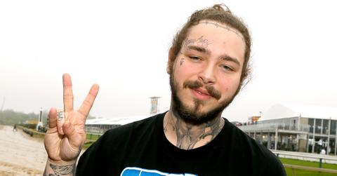 Post Malone makes a peace sign