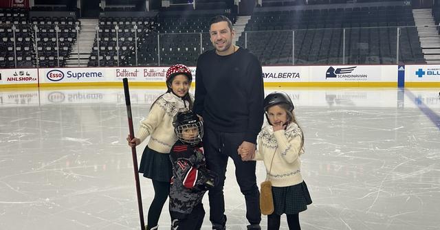 Milan Lucic and his kids at a hockey rink