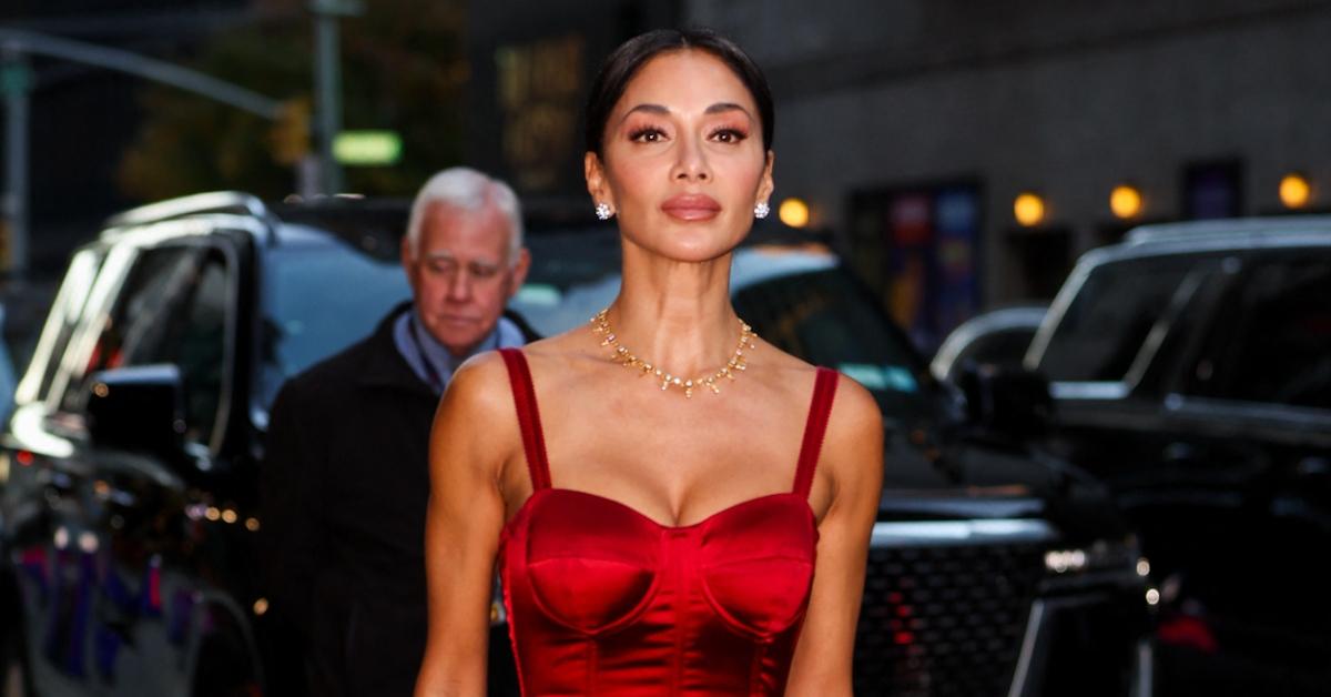 Nicole Scherzinger wearing a silk red dress.