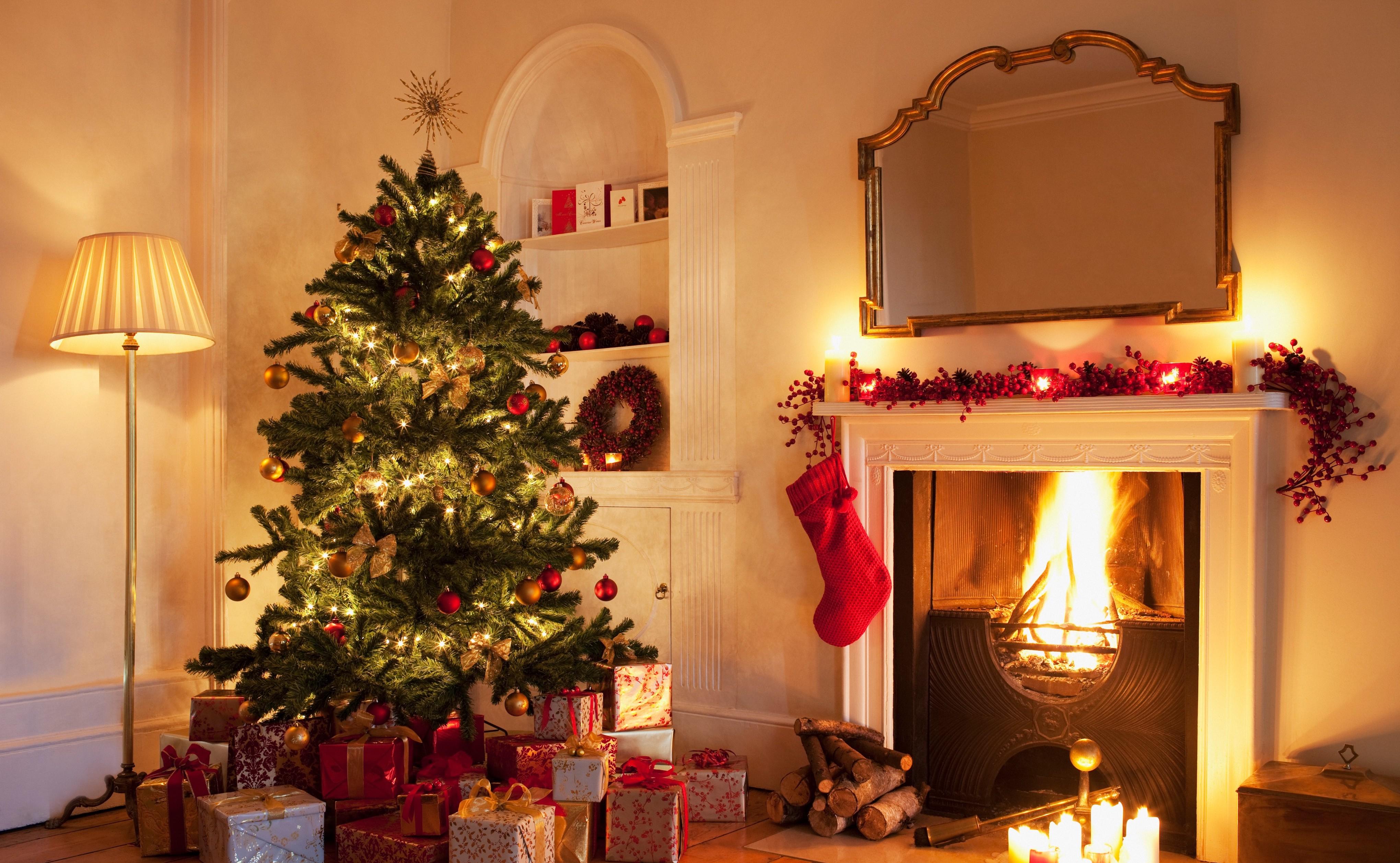 Christmas tree with gifts near fireplace 
