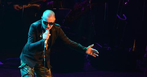 Sinéad O'Connor singing into a mic at a birthday celebration with Curtis Mayfield.