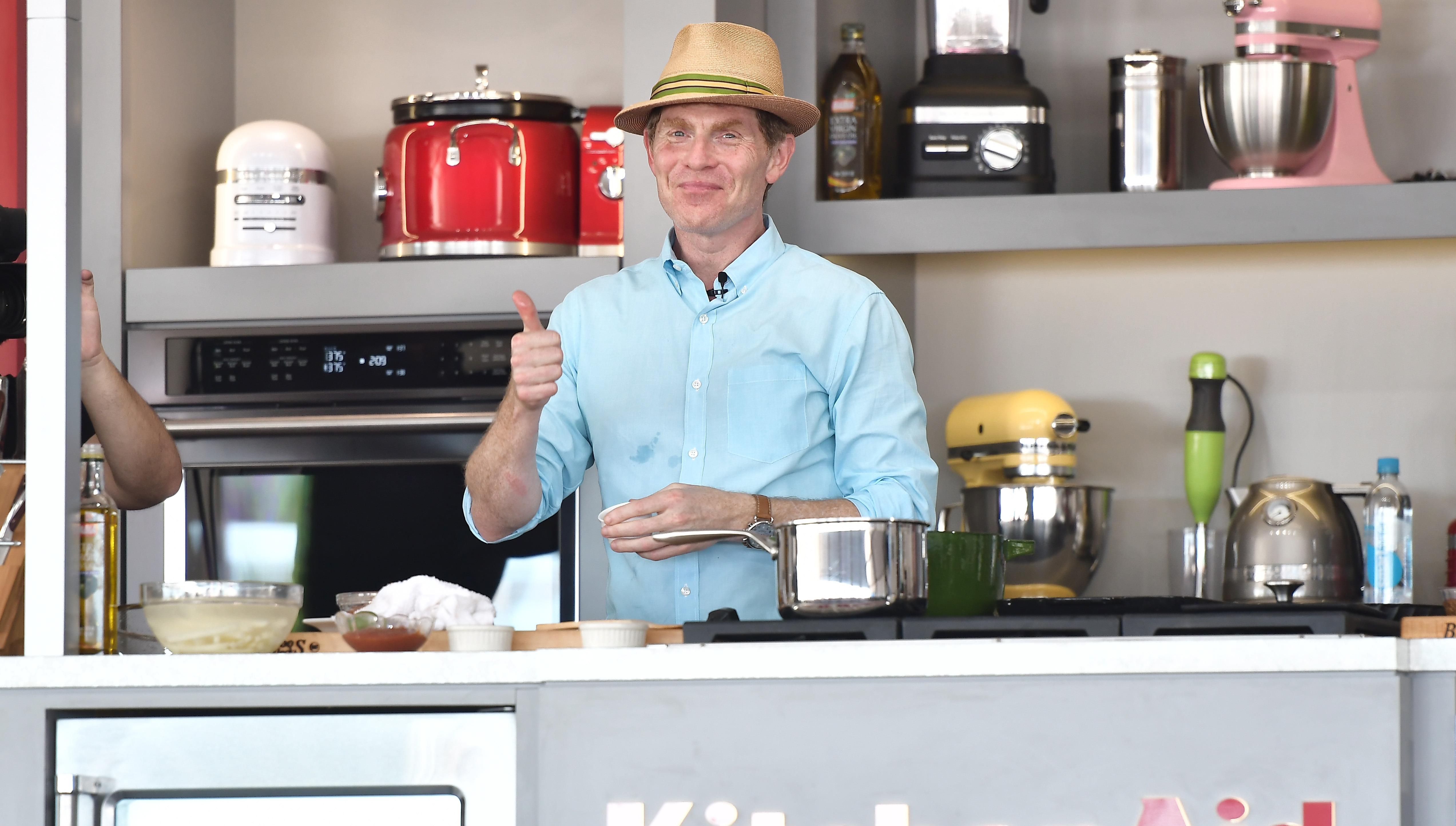 Bobby Flay doing thumbs-up sign while cooking