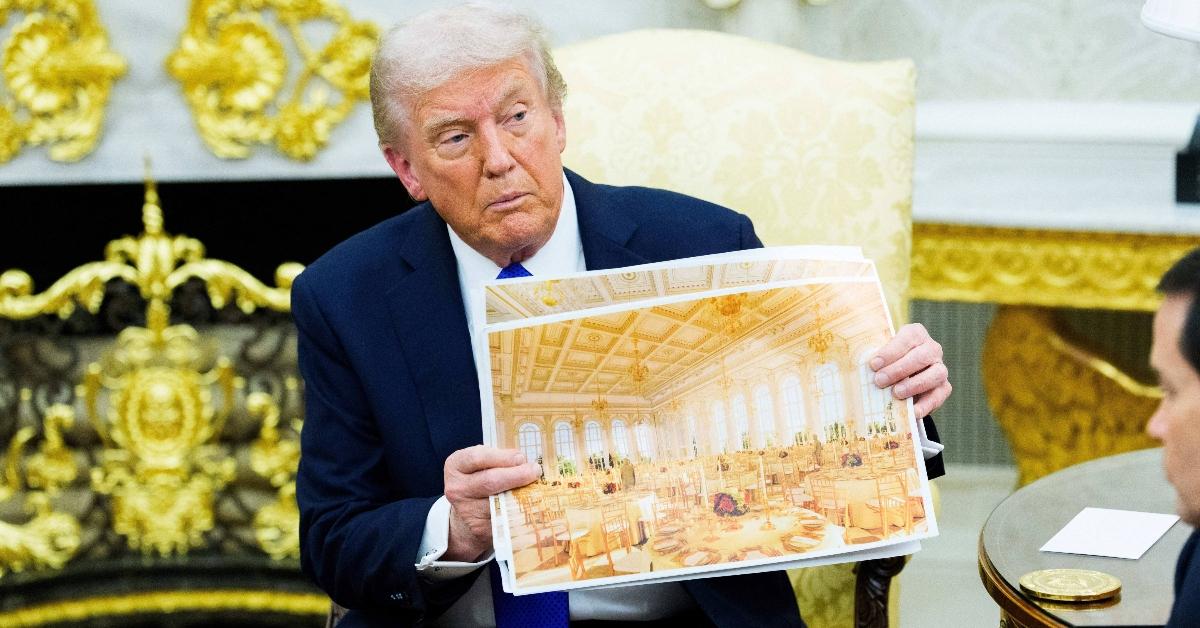 President Trump holding up a rendering of the new ballroom.