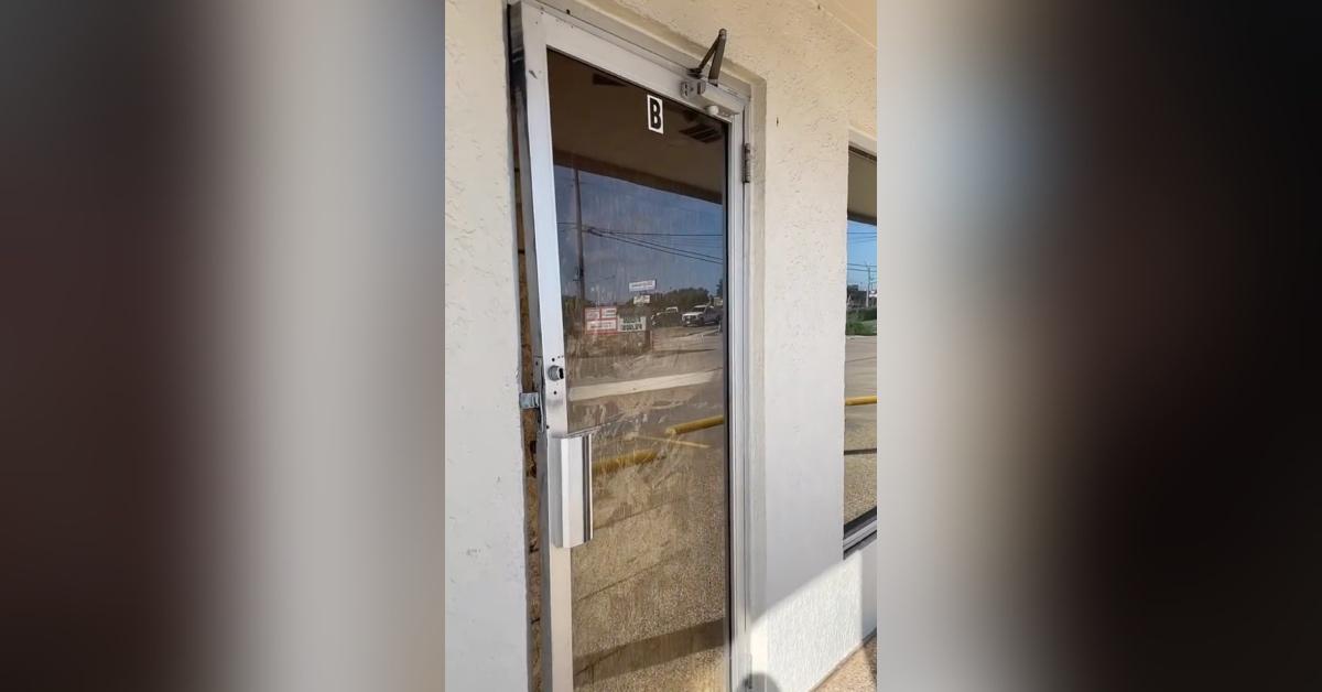 The boarded up storefront that had been a bridesmaid alteration business