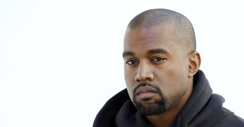 Kanye West in a black hoodie.