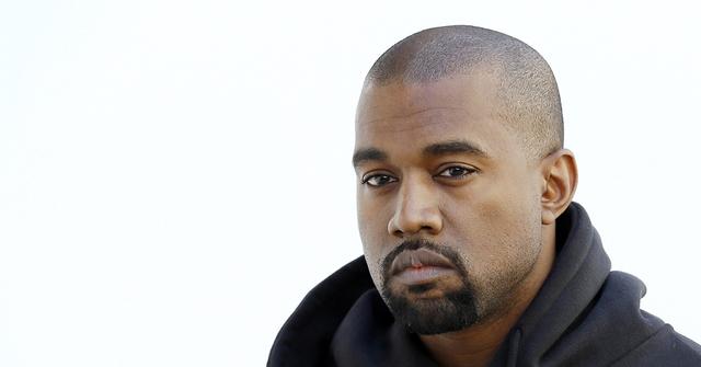 Kanye West in a black hoodie.